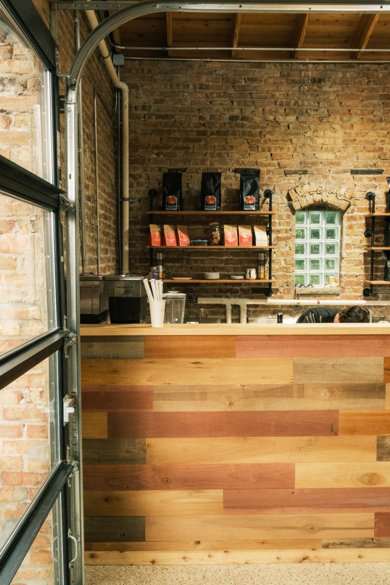 The multitone wood counter, coffee shelves, and original brick viewed through the garage door