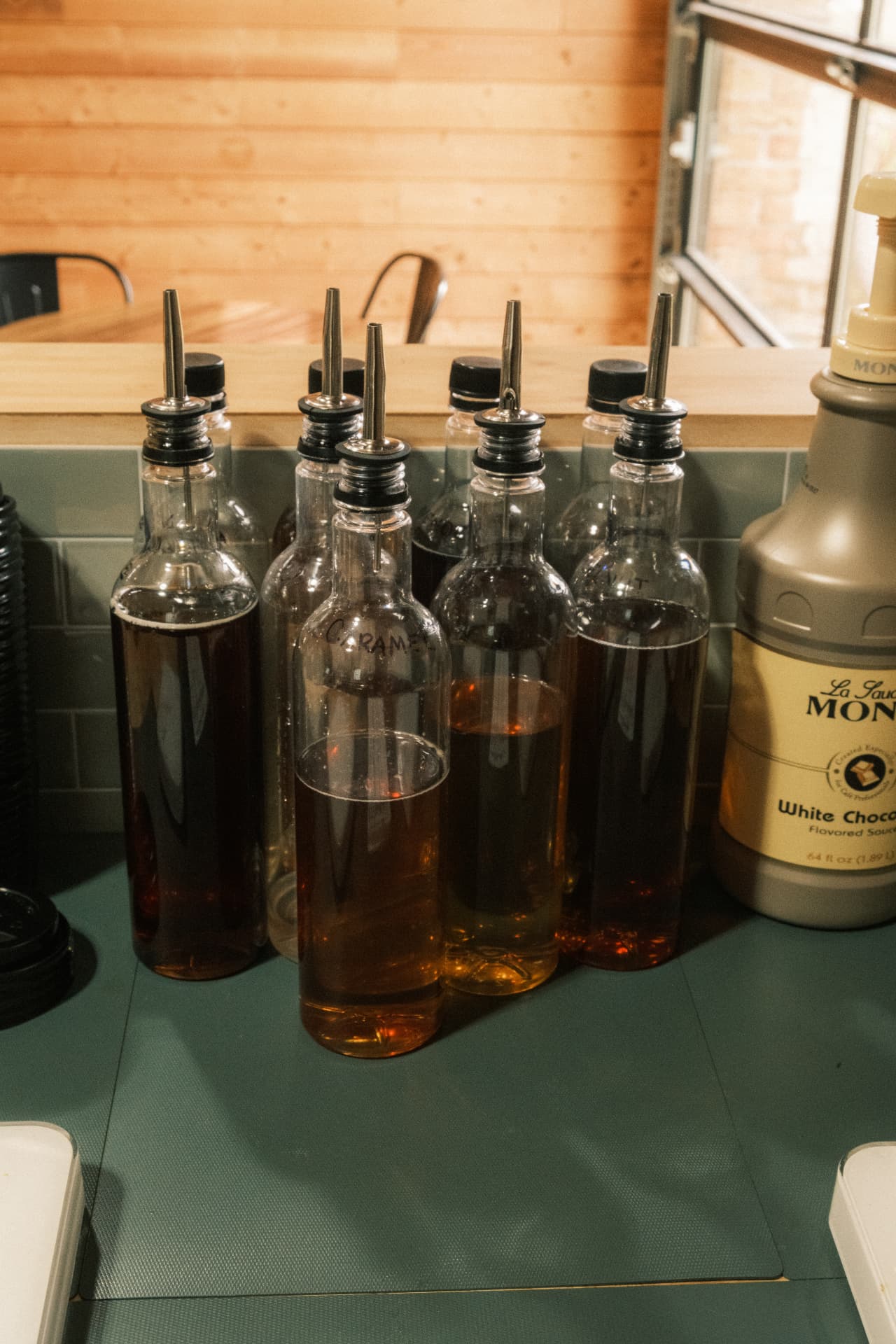 House drink syrups lined up behind the DSCO counter