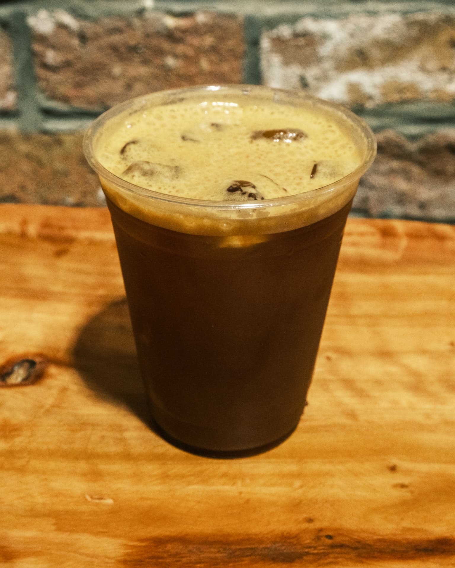 An iced DSCO cold brew in a tall glass with a DSCO Coffee logo on the cup